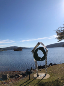 Wreath by a peaceful lakeside on a sunny day.